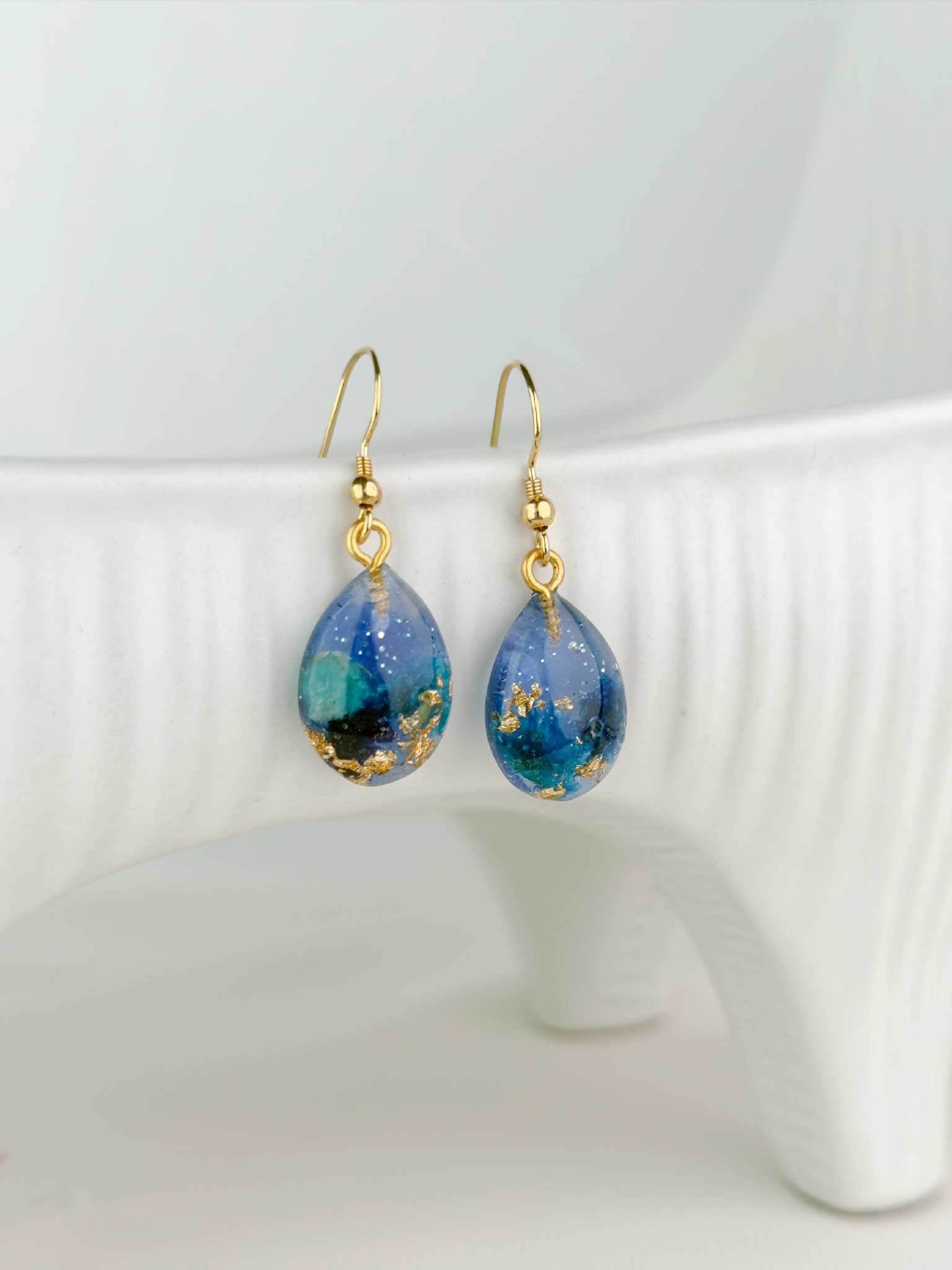 Kismo Blossom drop earrings in ocean blue, botanical resin jewelry, Close up handmade in Los Angeles